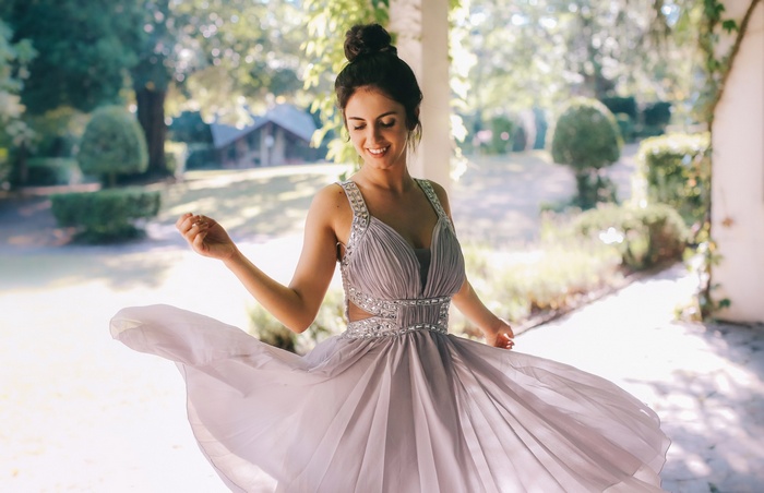 Aurela Skandaj in a flowing white dress outdoors