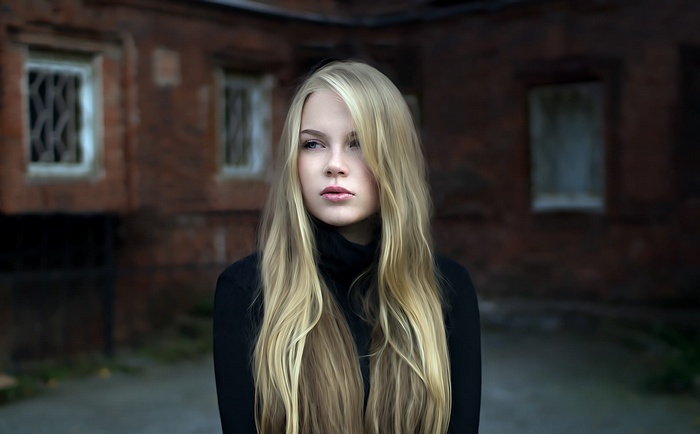 Portrait of a blonde woman in a black turtleneck