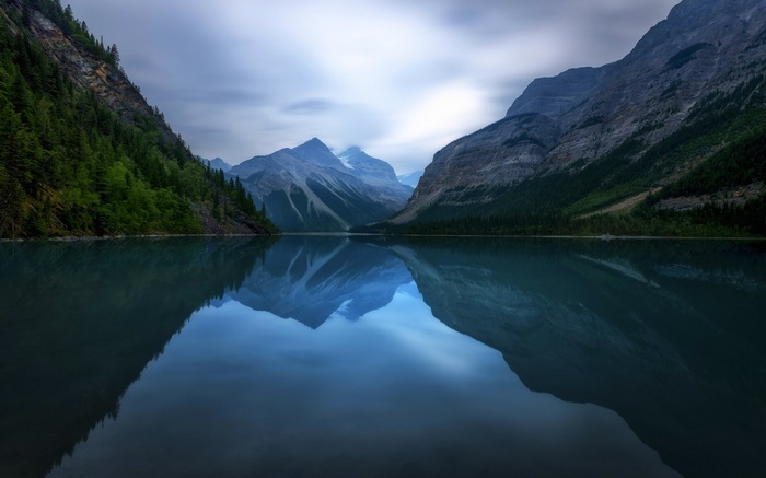 Mountains reflected in a calm lake in British Columbia, Canada