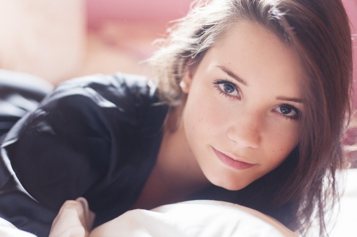 Laura Andrea Schönborn in bed looking at viewer