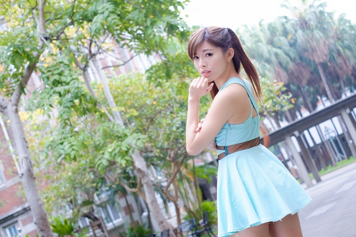Asian woman in blue dress outdoors