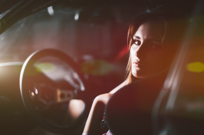 Woman sitting in a car at night