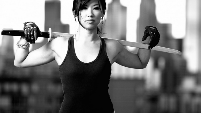Asian woman holding a sword