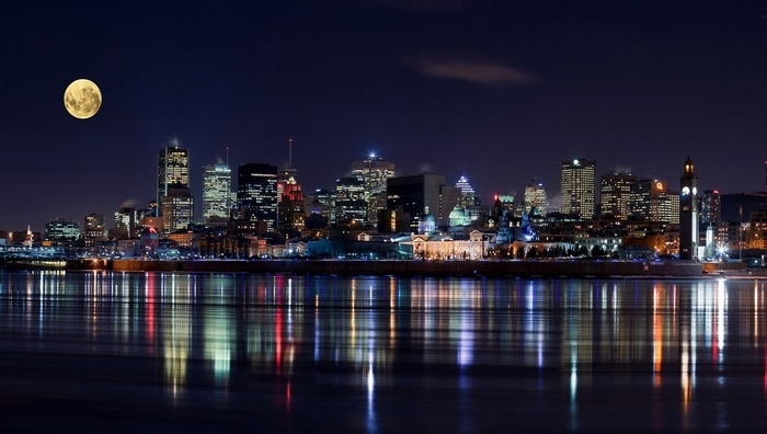 Montreal cityscape at night with a full moon
