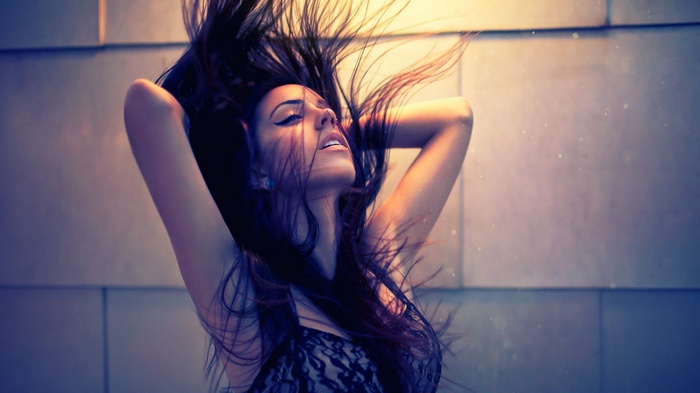 Hannah Ray with her hands in her dark hair