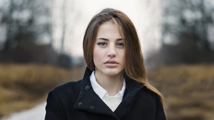 Woman with dark coat and white shirt