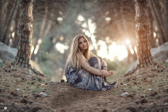 Woman sitting on a forest path