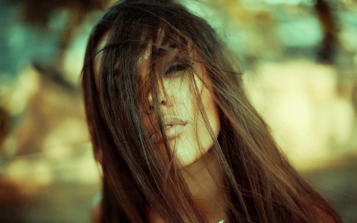 Brunette woman with long hair in her face