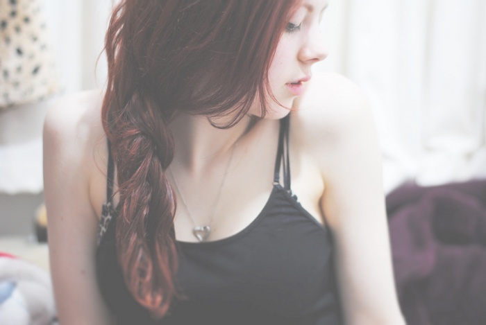 Redhead woman with braided hair and necklace
