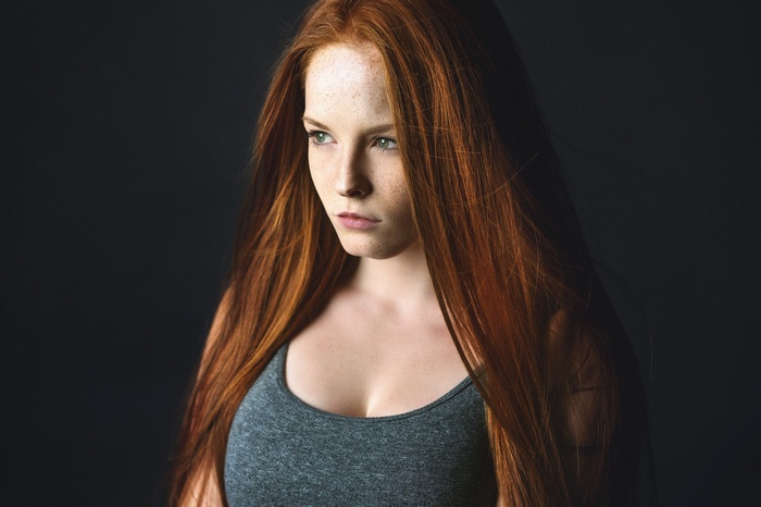 Redhead woman with green eyes looking away