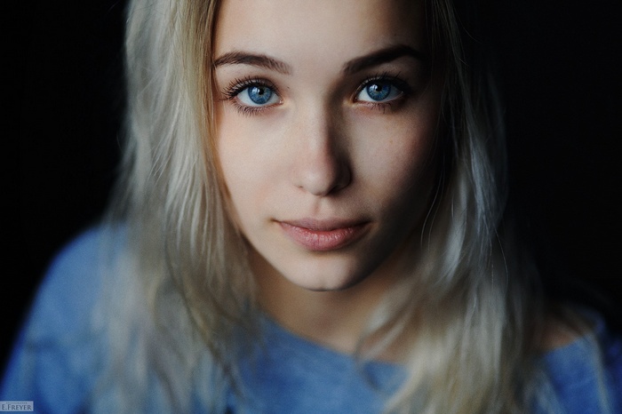 Portrait of a young woman with blue eyes and blonde hair