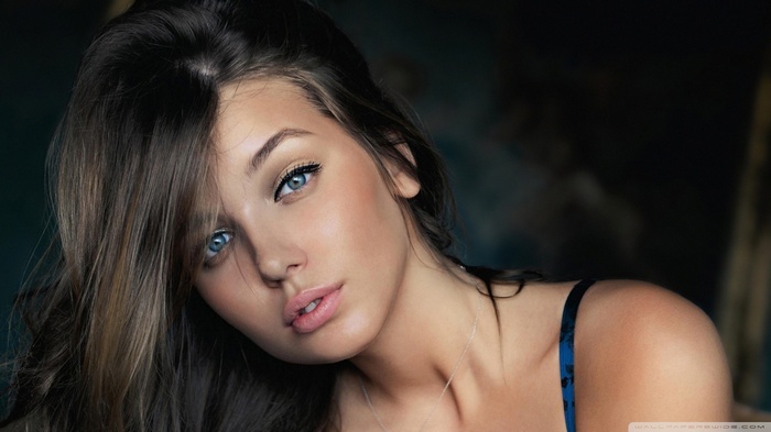 Close-up portrait of a young woman with blue eyes
