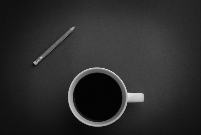 A cup of coffee and a pencil