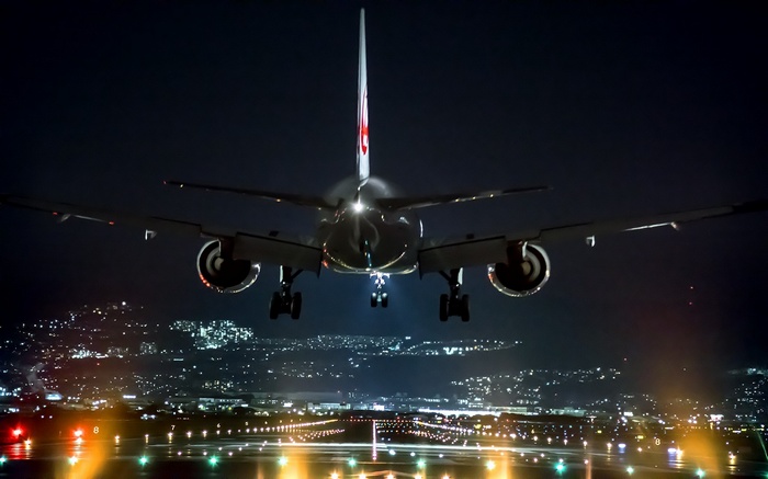 Airplane landing at night in Osaka, Japan