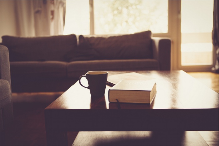 Coffee cup and book on a coffee table