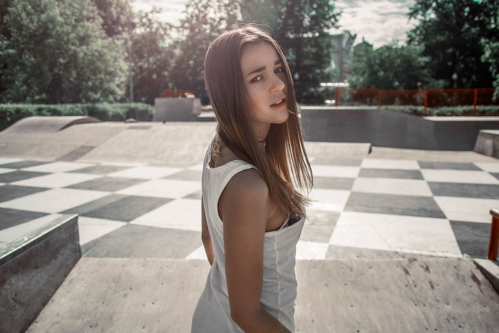 Woman in white top at a skatepark