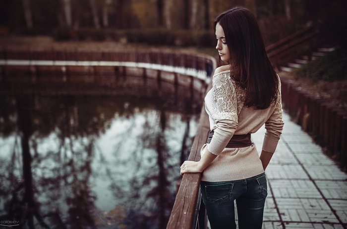 Woman with long hair by a lake