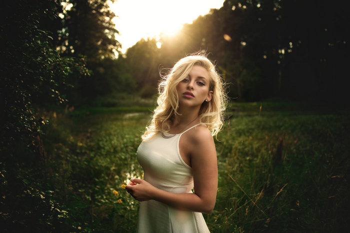 Woman in a white dress outdoors at sunset
