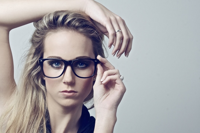 Woman with blonde hair and blue eyes wearing glasses