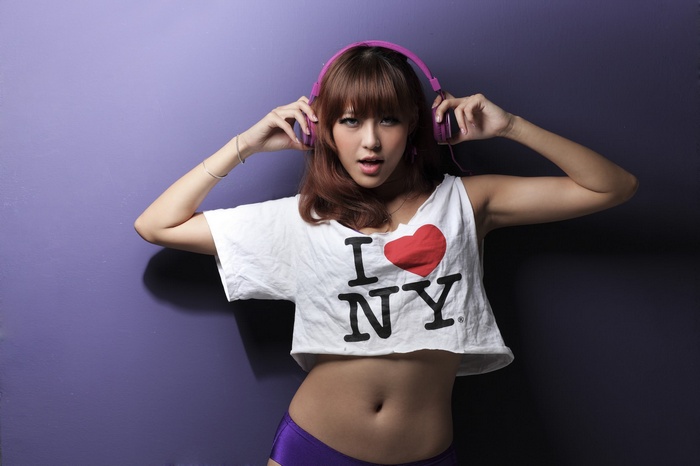 Woman wearing headphones and I Love NY shirt