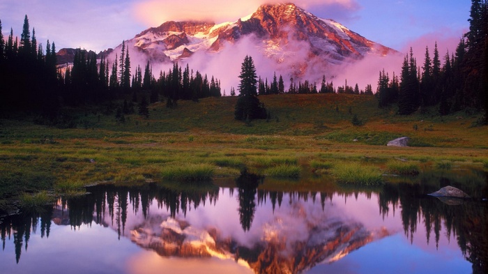 Mountain reflection in a calm lake at sunset