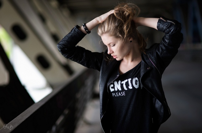 Woman in leather jacket with text on shirt