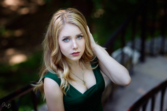Woman with blonde hair wearing a green dress