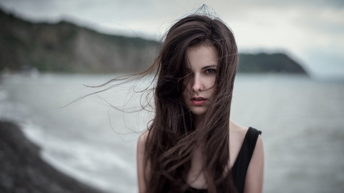 Woman with long brown hair in the wind outdoors