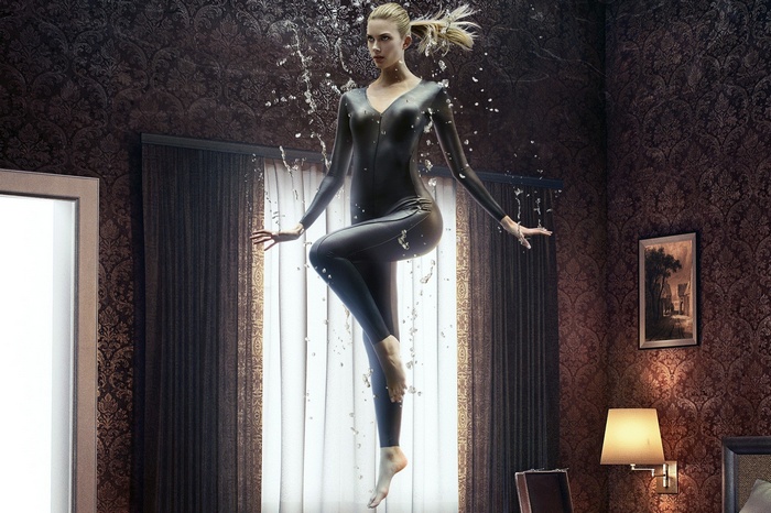 Emma Ishta in a black catsuit with water splashing
