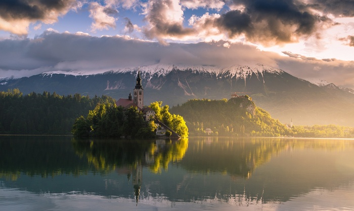 Lake Bled island church and castle with snowy mountains