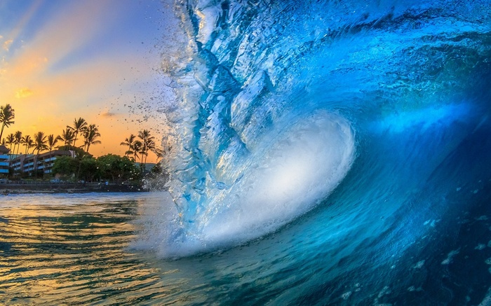 Wave crashing on a Hawaiian beach at sunset