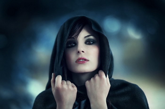 Woman in a dark hooded cloak
