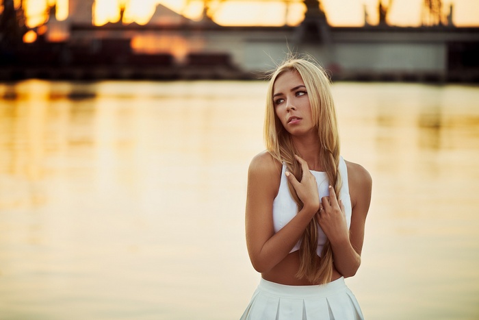 Woman with blonde hair wearing a white skirt and top