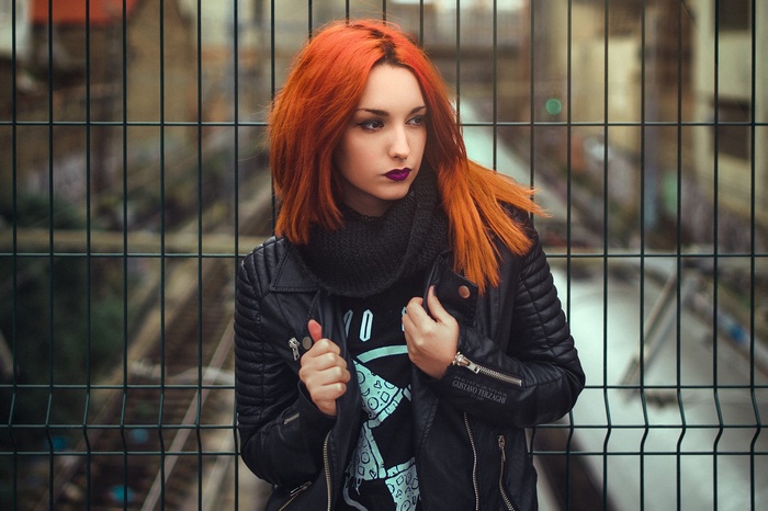 Woman with red hair and black jacket