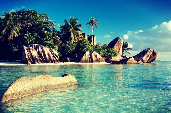 Tropical beach with granite boulders and clear turquoise water