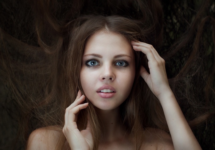Portrait of a young woman with long brown hair