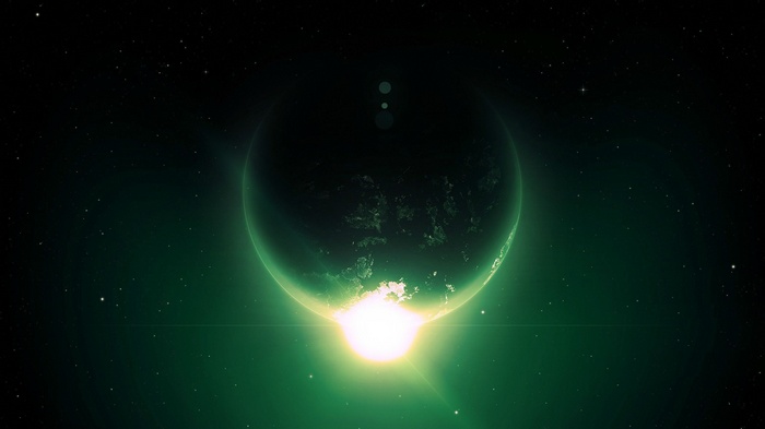 Green planet with bright sunrise in space