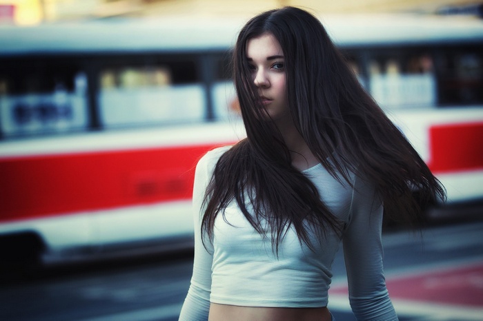 Woman with long dark hair in urban setting