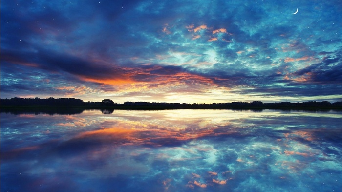 Sunset over a calm lake with reflections