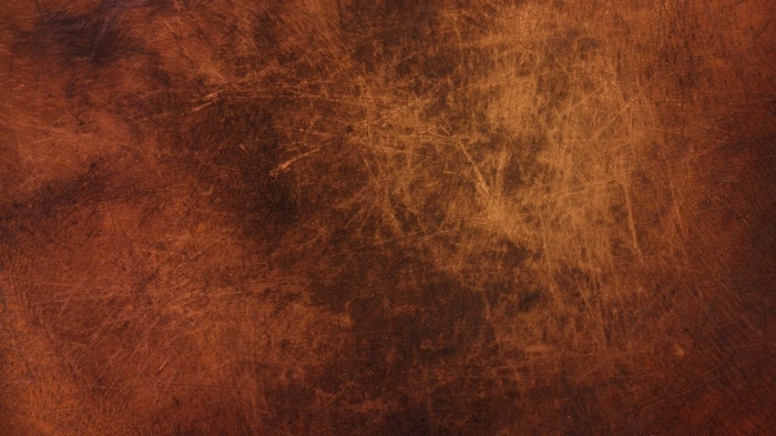 Textured brown surface with scratches