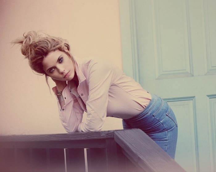 Ashley Benson leans on a railing