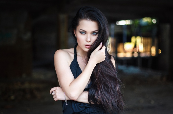 Woman in black dress with long dark hair