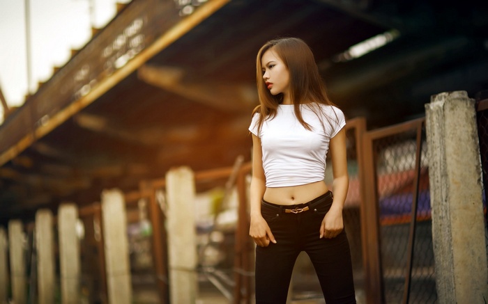 Asian woman in white crop top and black pants