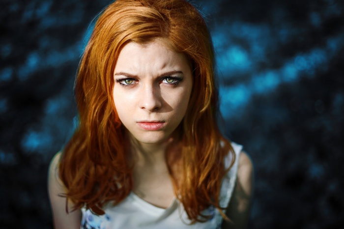 Portrait of a young redhead woman with green eyes