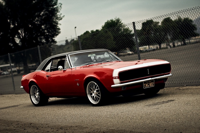 Red Chevrolet Camaro RS parked on asphalt