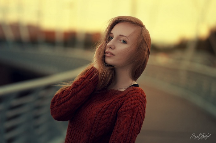 Redhead woman in a knitted sweater