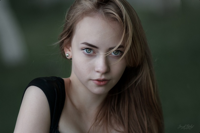 Portrait of a young woman with blonde hair and green eyes