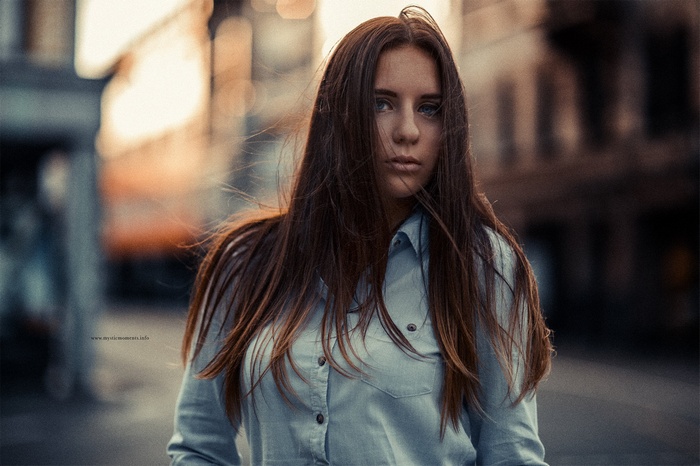 Woman with long brown hair in a blue shirt