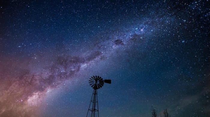 Milky Way over a silhouette windmill at night