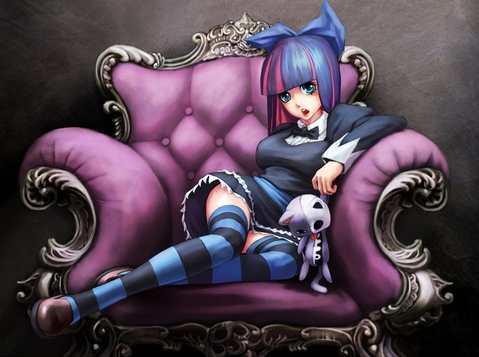 Anarchy Stocking sitting on a purple chair with a doll